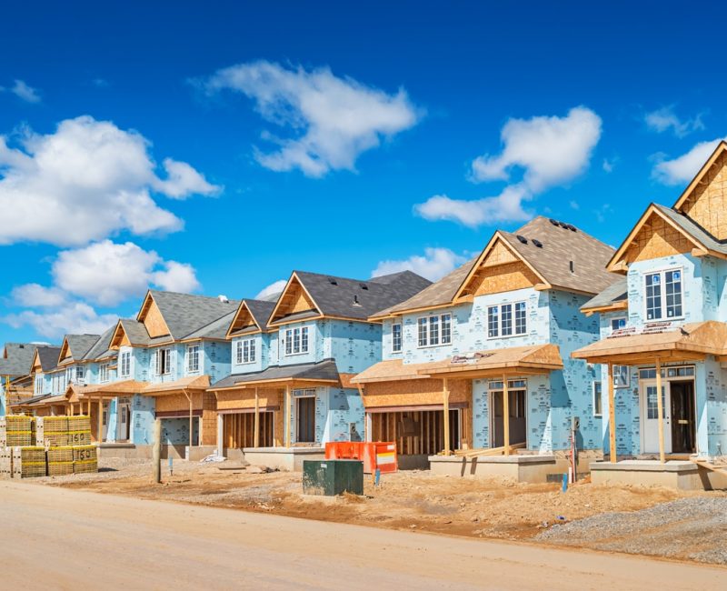 New houses are under construction in a new residential district in Brantford Ontario Canada on a sunny day.