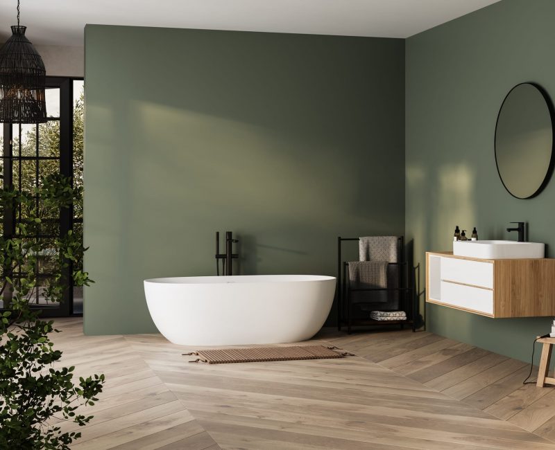 Modern minimalist bathroom interior, bathtub and bathroom cabinet, white sink, interior plants, bathroom accessories, parquet floor, green wall.