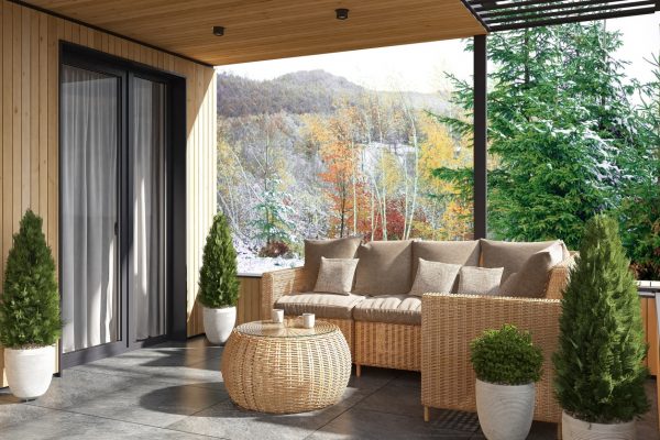 This tranquil winter scene captures a stylish villa terrace furnished with classic rattan seating, including a sofa and armchair around a round table. The snowy backdrop features majestic mountain hills and snow-dusted fir pine trees, creating a serene and idyllic atmosphere. The warm pine wood paneling on the villa’s facade contrasts beautifully with the winter landscape, while the large grey stone tiles on the floor enhance the natural elegance of the space. Large glass doors provide easy access to this picturesque winter terrace.

This image is perfect for real estate listings, winter vacation marketing, and lifestyle content focused on mountain retreats, cold-weather destinations, or luxury homes in snowy climates. It can also be used in design inspiration for winter-themed outdoor spaces and seasonal outdoor living.